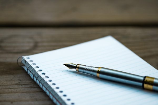 买号相关公开资料被按年份装订成册摆在木架上，纸页泛黄边缘有翻旧的痕迹与灰尘颗粒感